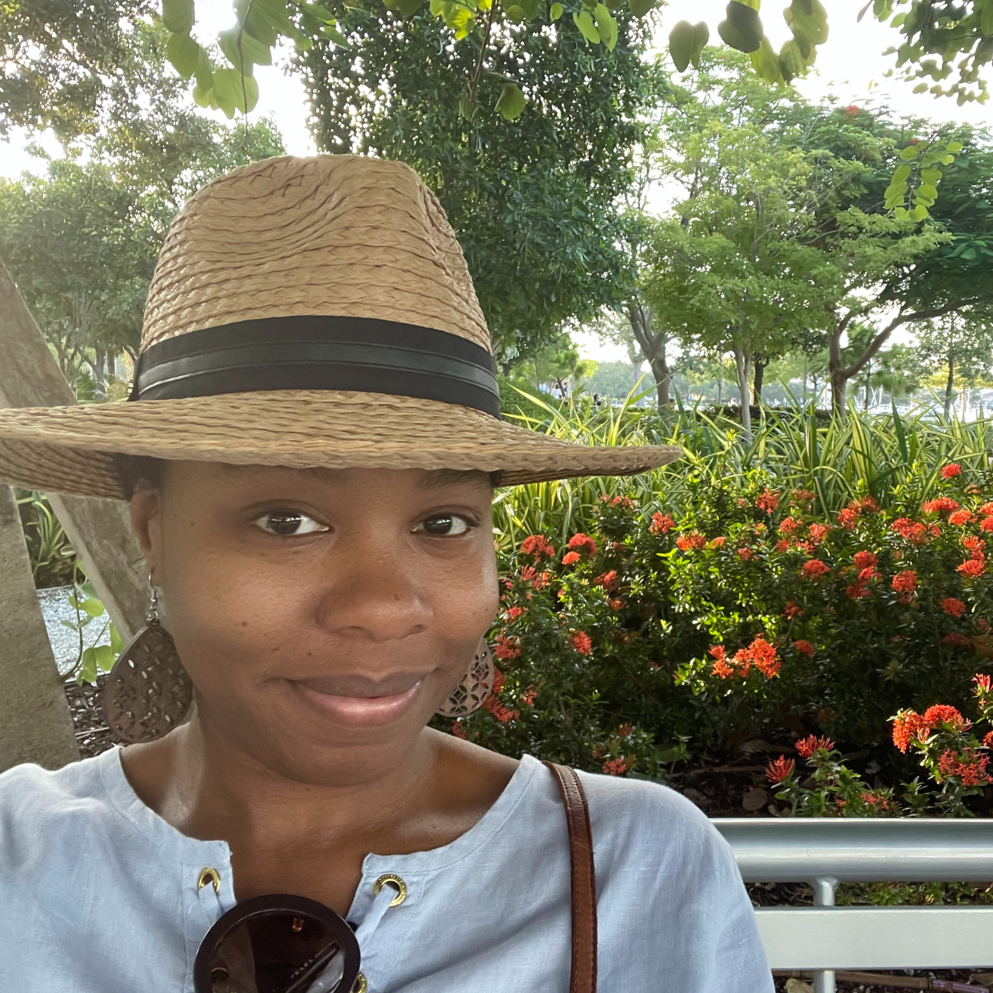SEO agency owner Geneva Bell wearing a pink sweater with metal hearts in the background.